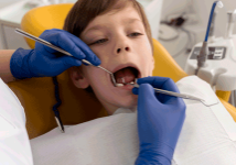 dentist-cleaning-child-s-teeth-stafford